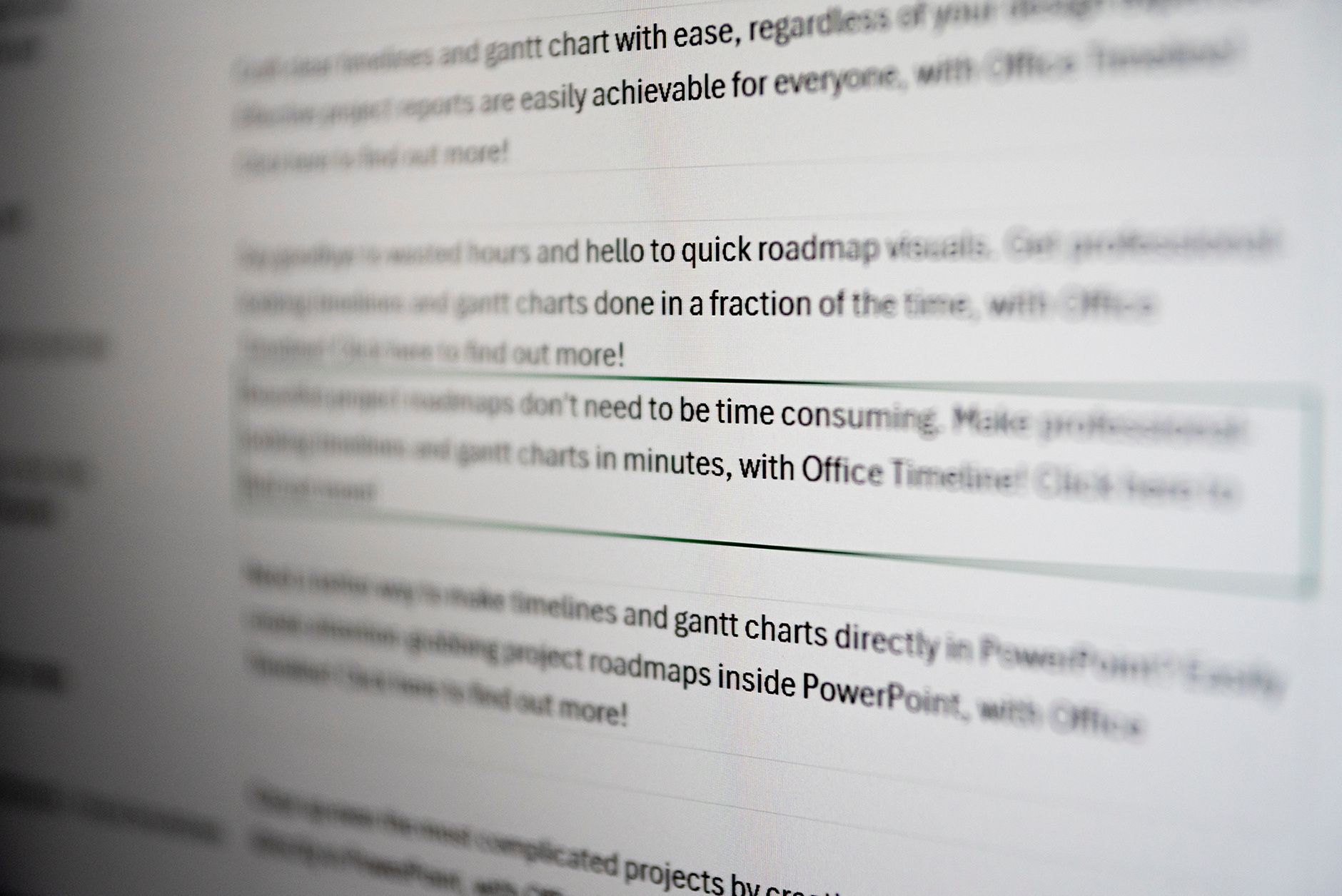 Blurred close-up of ad copy mentioning roadmap visuals and Gantt charts made in minutes